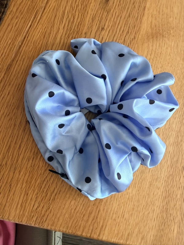 Close-up of the light blue scrunchie gathered on a wooden surface